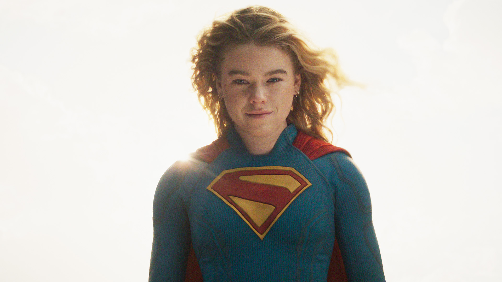 Milly Alcock's Kara Zor-El smiling and looking directly at the camera in 2026's Supergirl movie