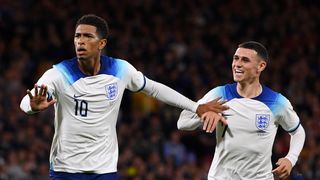 Jude Bellingham of England celebrates with teammate Phil Foden ahead of the England vs Brazil live stream