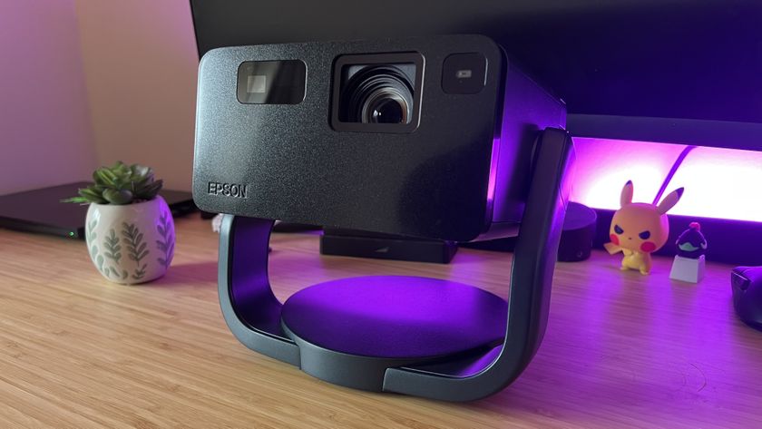 Epson EF-22 projector on a wooden desk with purple lighting