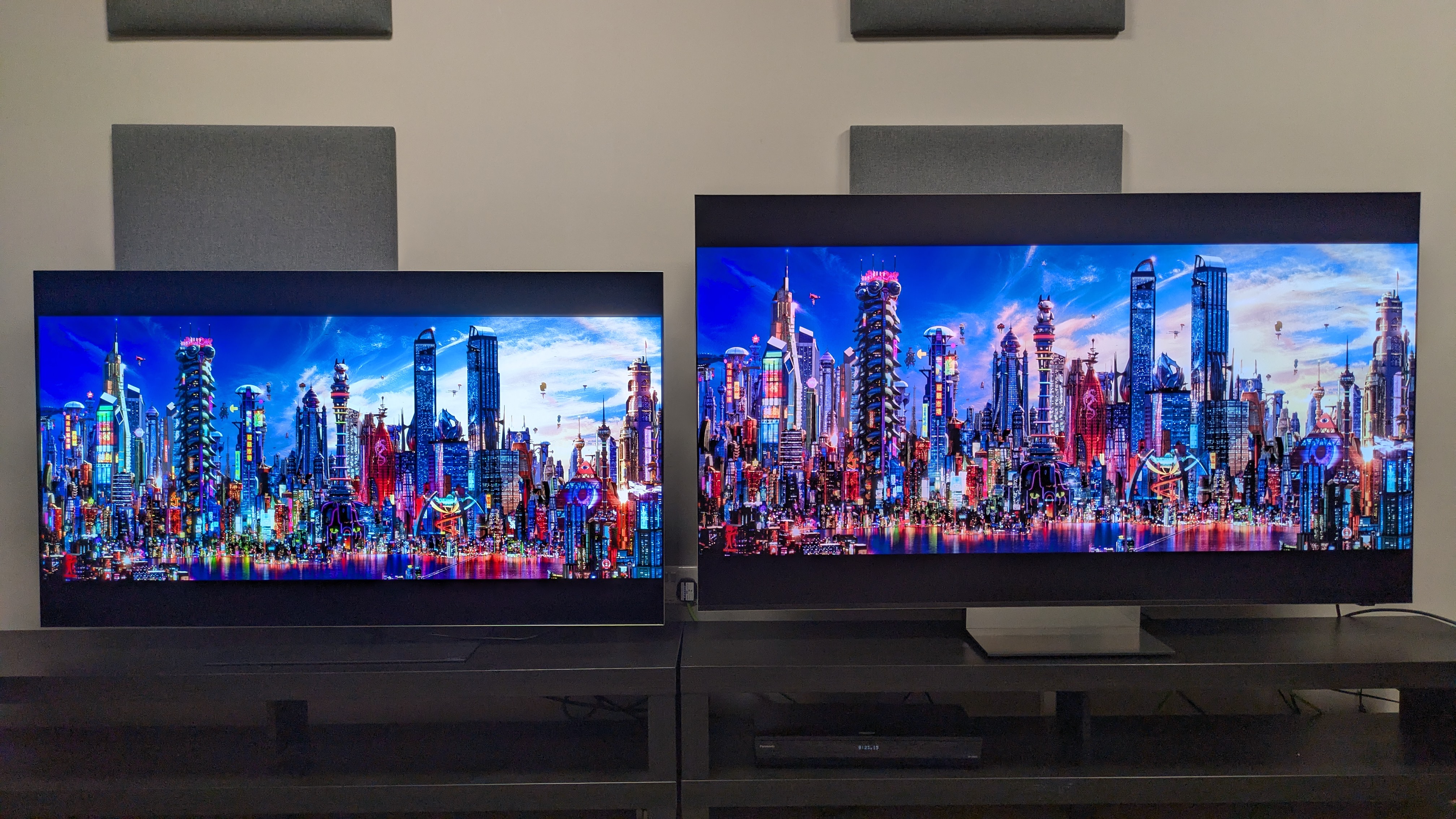 LG G6 (left) vs Samsung R95H (right) showing a shot of a city from Speed Racer on screen. Both TVs deliver good brightness, but the G6 has punchier highlights, thanks to its higher peak brightness