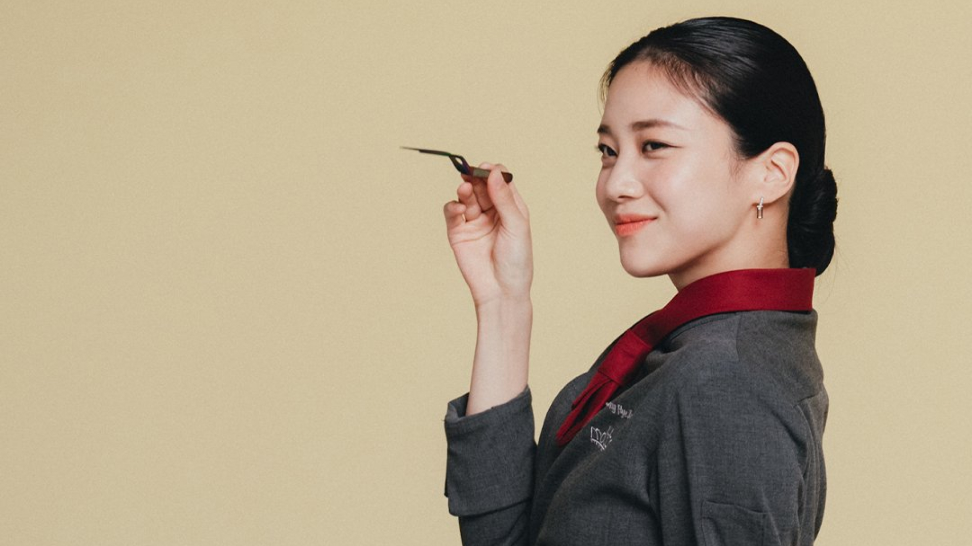 Hong Hwa-yeon, wearing a chef's outfit and posing with a cooking tool, in the Korean drama 'Tastefully Yours.'