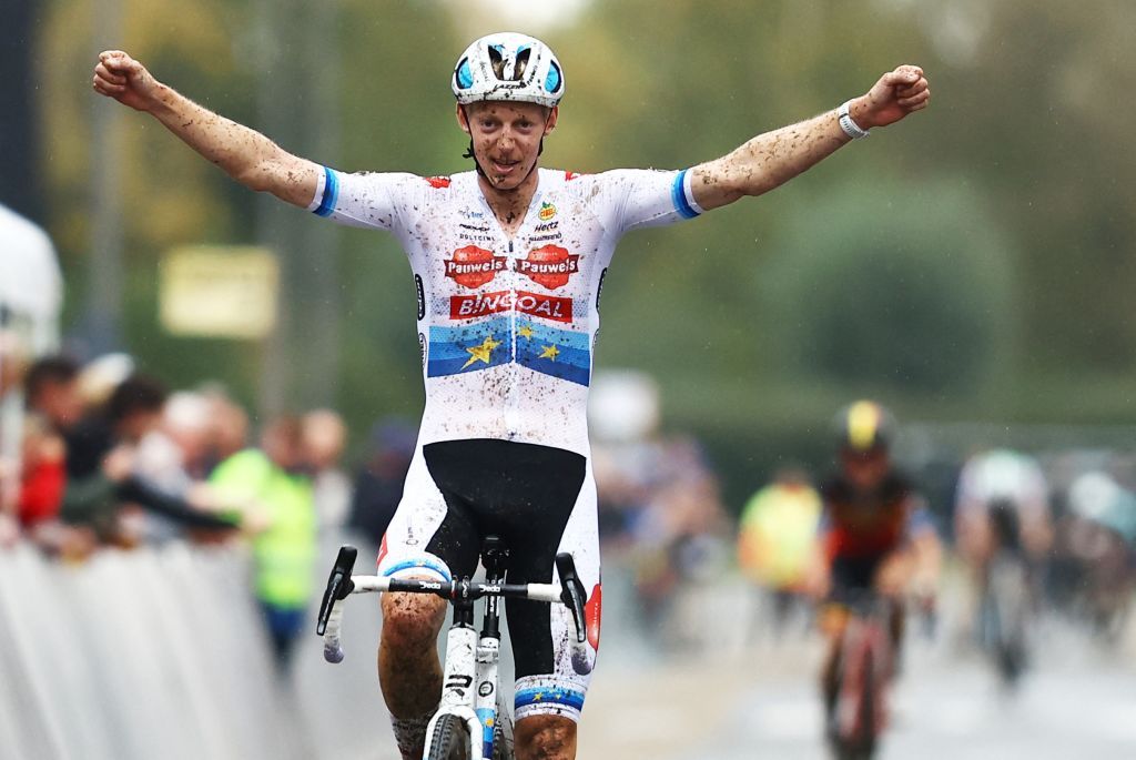 Michael Vanthourenhout celebrates as he crosses the finish line to win the men&#039;s elite race of Kermiscross