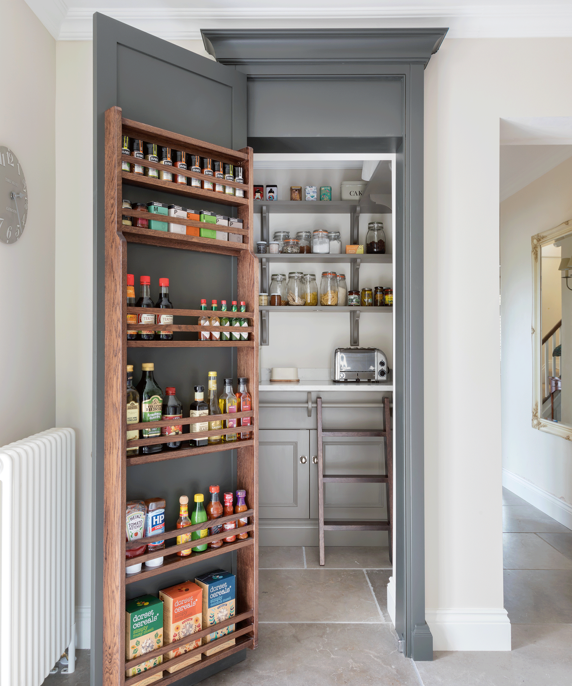 walk-in pantry with full length condiment rack on the door