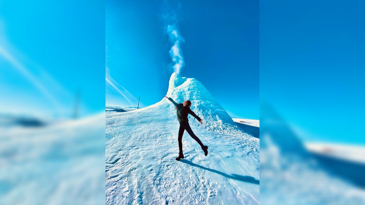 A visitor standing in front of the &#039;ice volcano&#039; in Kazakhstan.