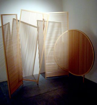 Three wooden screen-space dividers. Two in tall rectangular shape and one in a circular shape.