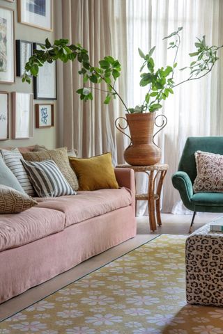 living room with pink sofa and plant