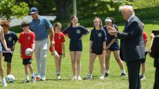 President Donald Trump speaks to kids after signing a proclamation to restore the Presidential Fitness Test.