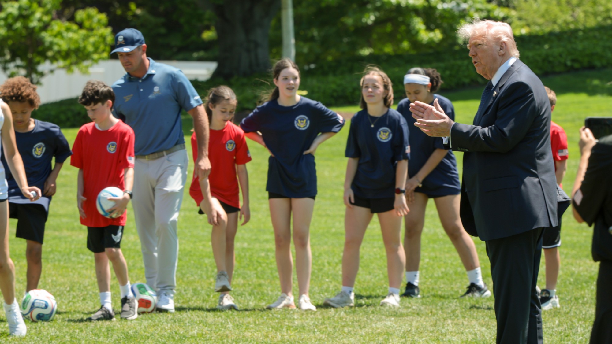 President Donald Trump speaks to kids after signing a proclamation to restore the Presidential Fitness Test.