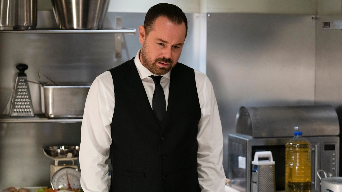 Danny Dyer in a black waistcoat and tie as Mick Carter in EastEnders