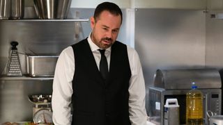 Danny Dyer in a black waistcoat and tie as Mick Carter in EastEnders