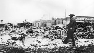 The remains of iron beds rise above the ashes of a burned-out block after the Tulsa Race Massacre, Tulsa, Oklahoma, in 1921.