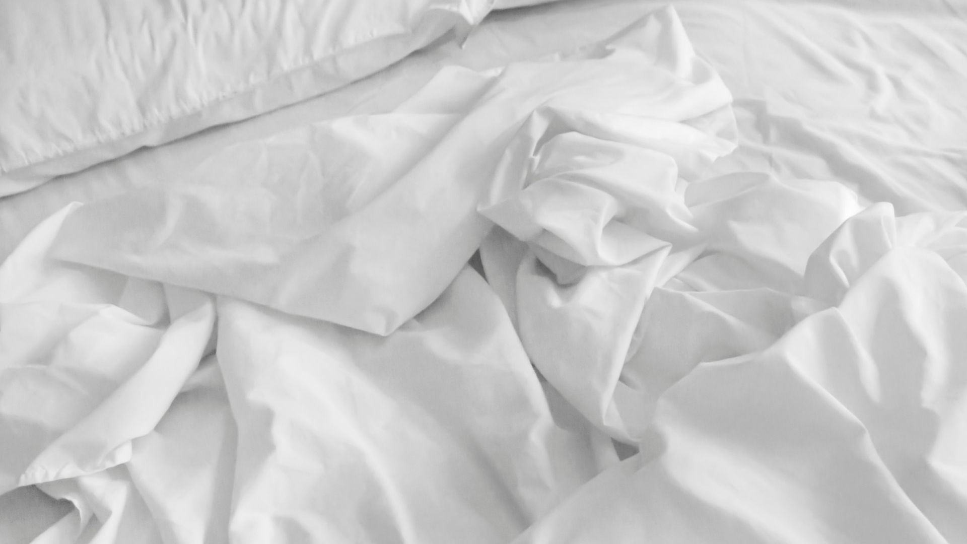 white sheets on bed
