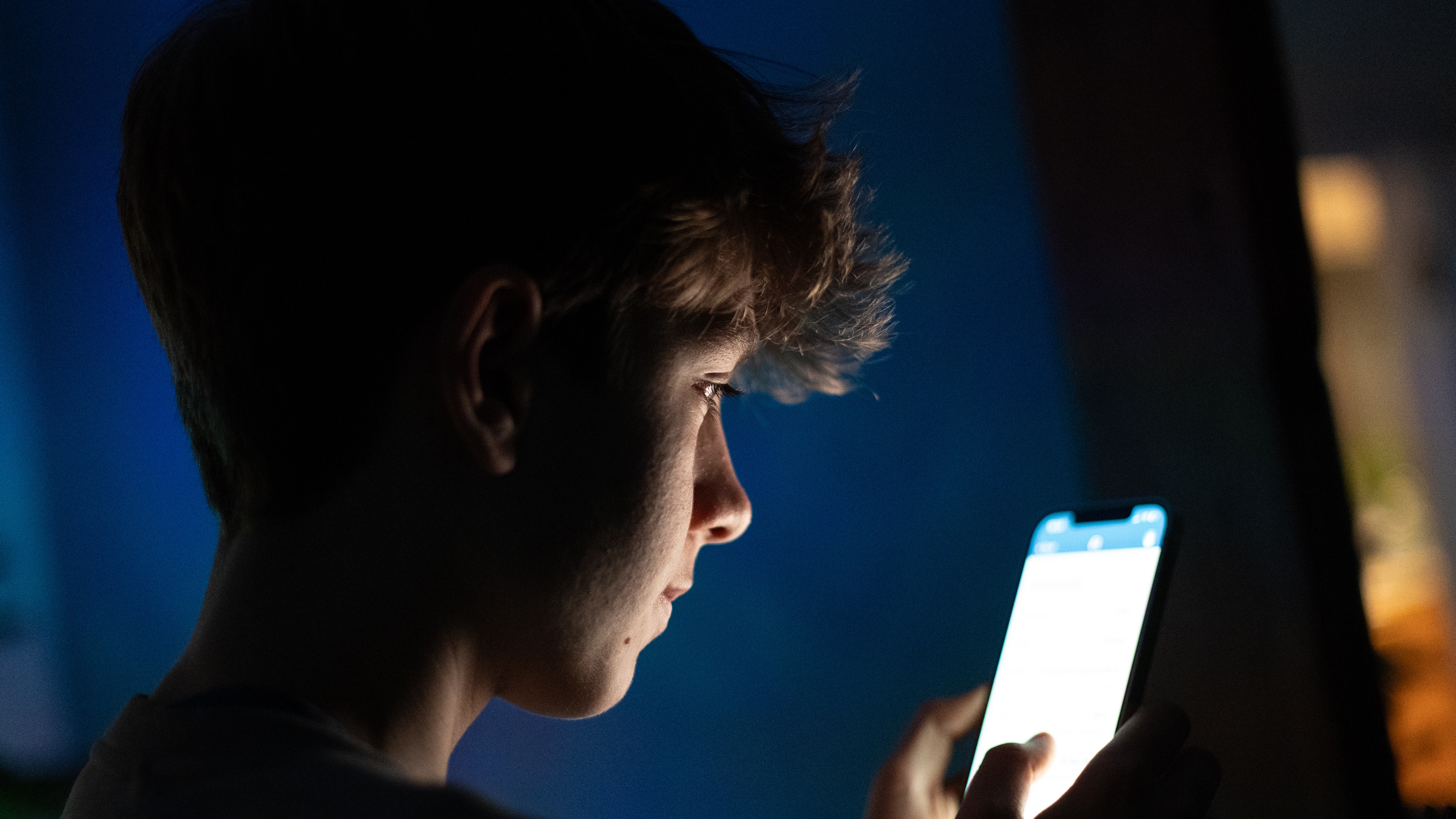 BATH, UNITED KINGDOM - DECEMBER 23: In this photo illustration a 13-year-old teenage boy looks at an iPhone screen displaying various social media apps on December 23, 2025 in Bath, England. Recently the Australian Senate passed a law to ban children under 16 from having social media accounts and social media platforms, including TikTok, Facebook, Snapchat, Reddit, X, formerly Twitter, and Instagram potentially being be fined for preventing children younger than 16 from having social media accounts. (Photo by Matt Cardy/Getty Images)