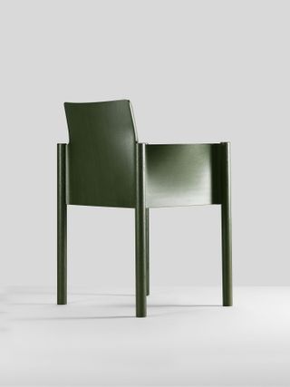 A green-coloured chair with four legs that rise up to connected with rectangular sides, which are a third of the height of the legs. The bag has a small back support above the back rectangular section.