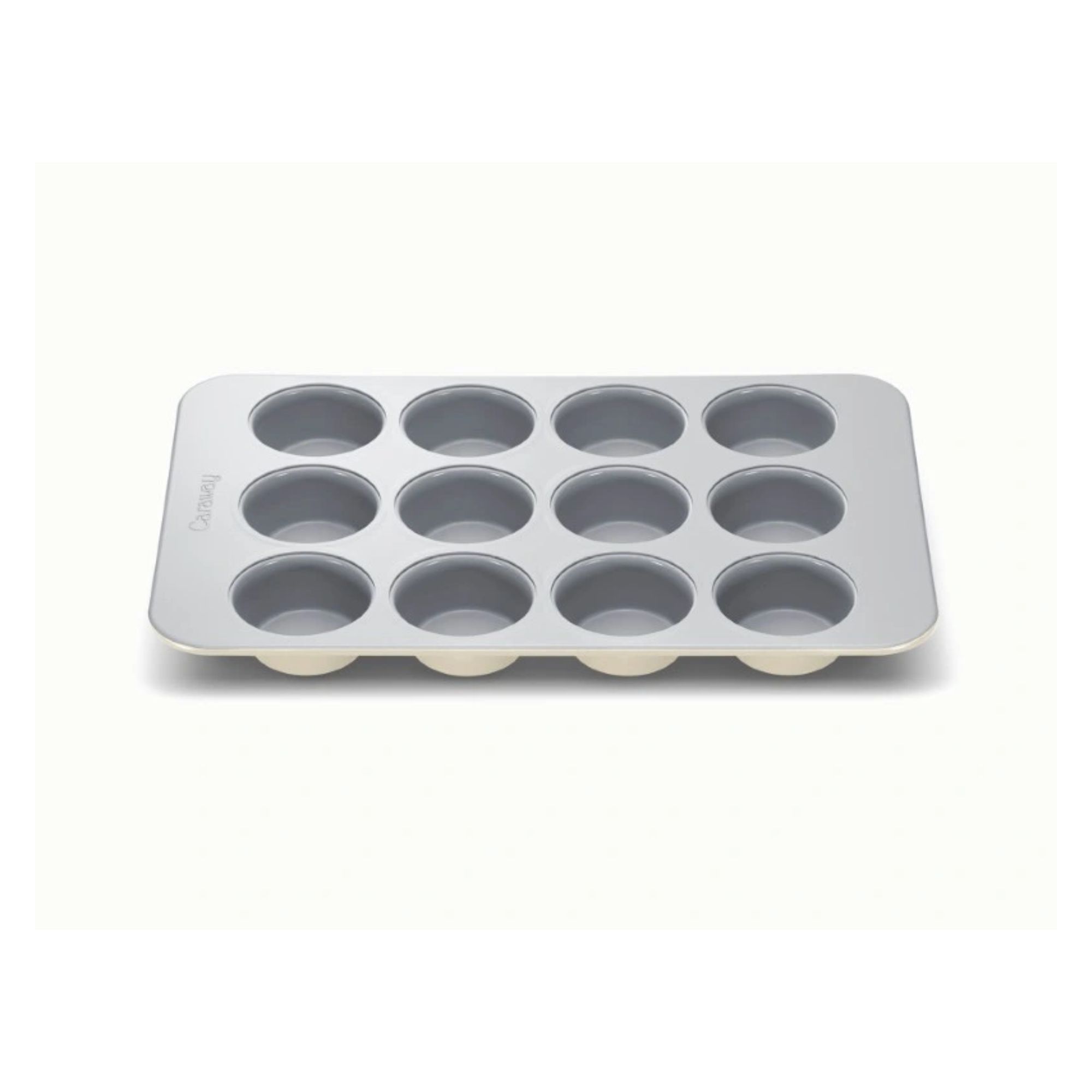 A cream 12-hole muffin tin on a white background.