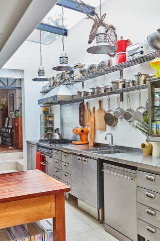 Industrial style kitchen in with open shelving and vintage lighting