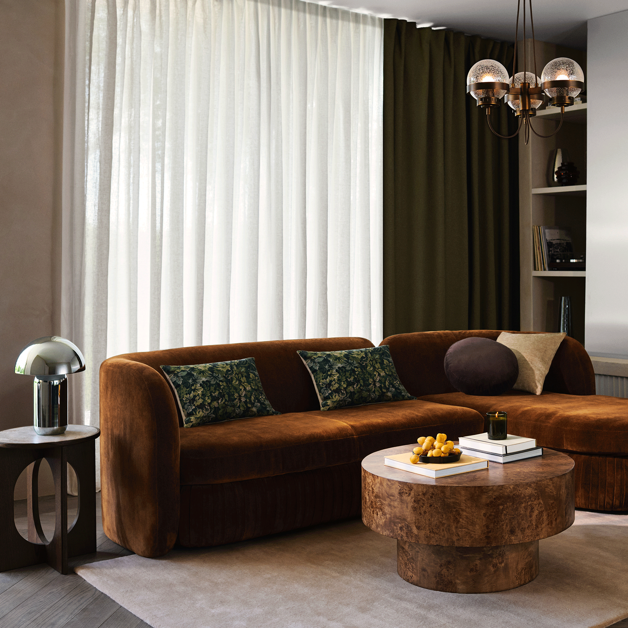 Ginger curved sofa with chrome lamp and wooden sidetable