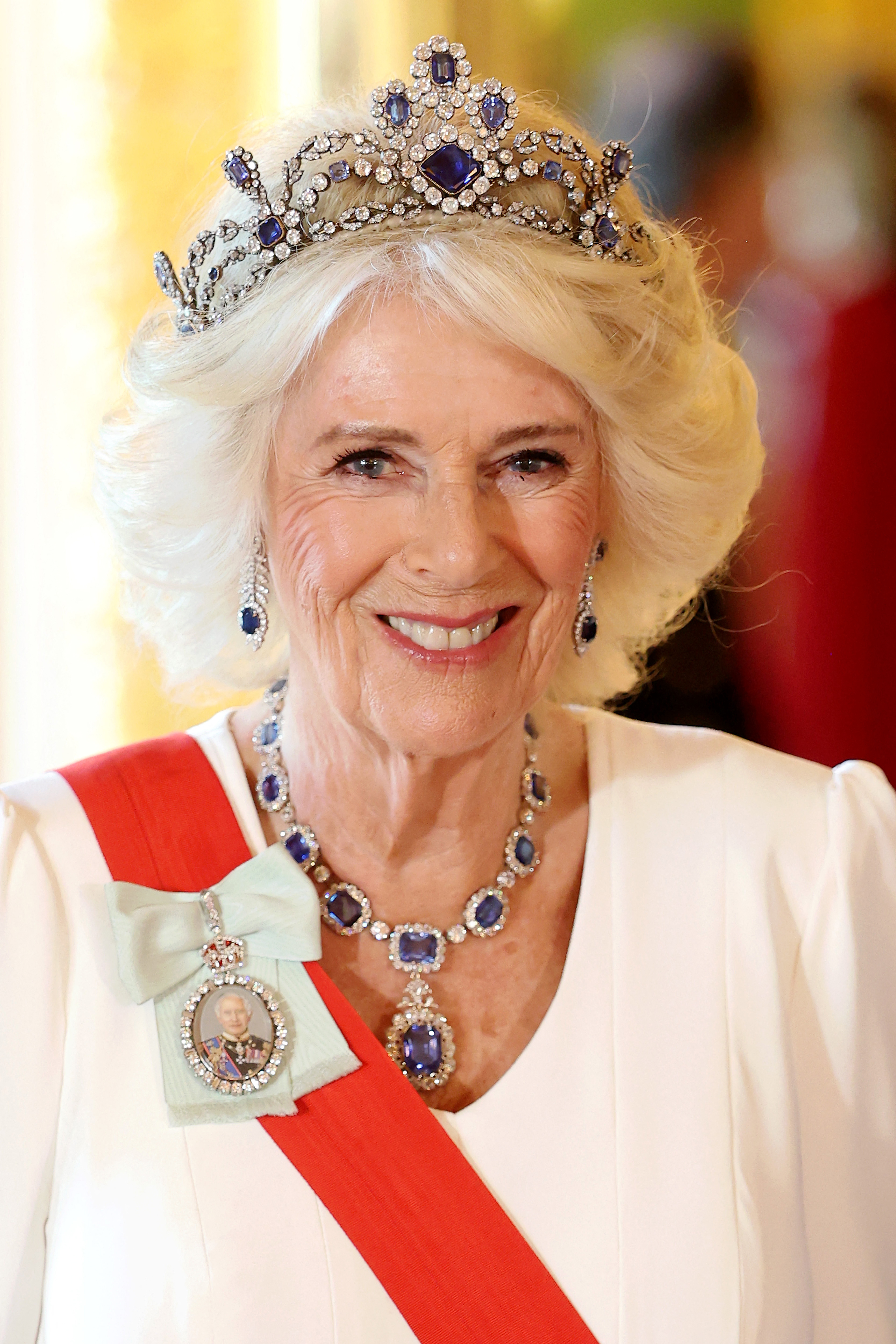 Queen Camilla attending a State Banquet at Windsor Castle in July wearing a miniature of Charles as a brooch