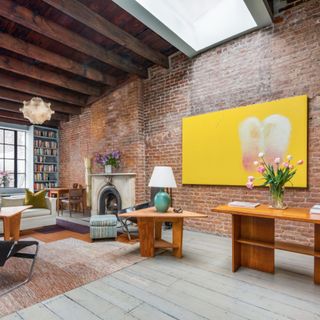 living room with wooden flooring and exposed brick walls