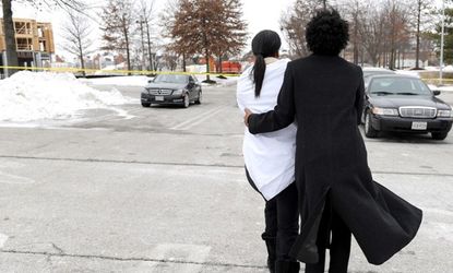 Two women console one another other after the shooting at the Columbia Town Center Mall.