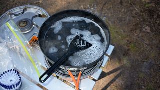 how to clean your camping stove: cleaning pots and pans