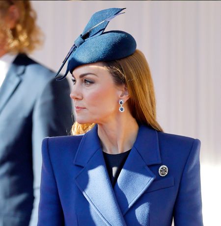 Kate Middleton wearing a blue coat and blue hat
