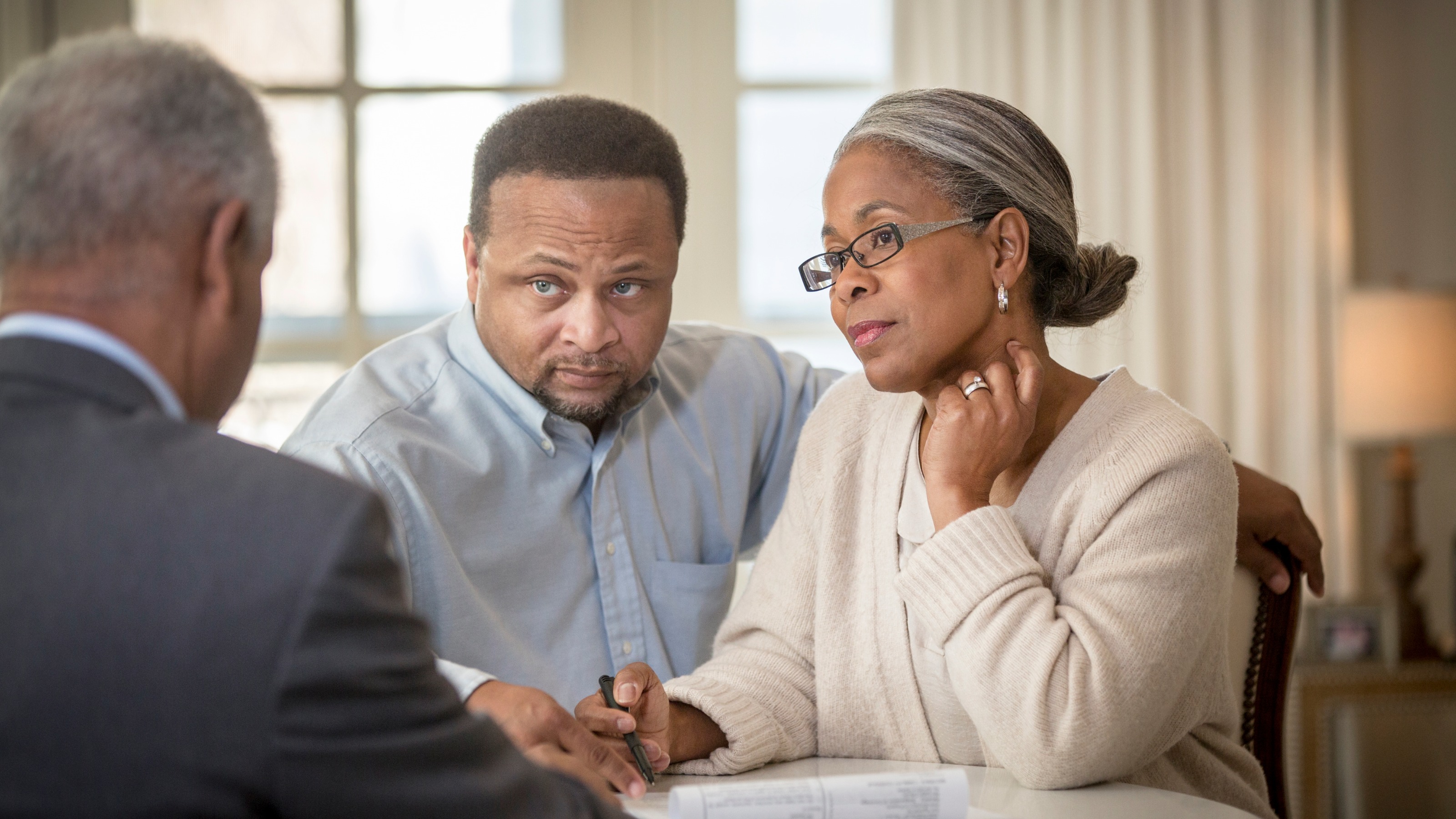 Mature couple talking to their adviser