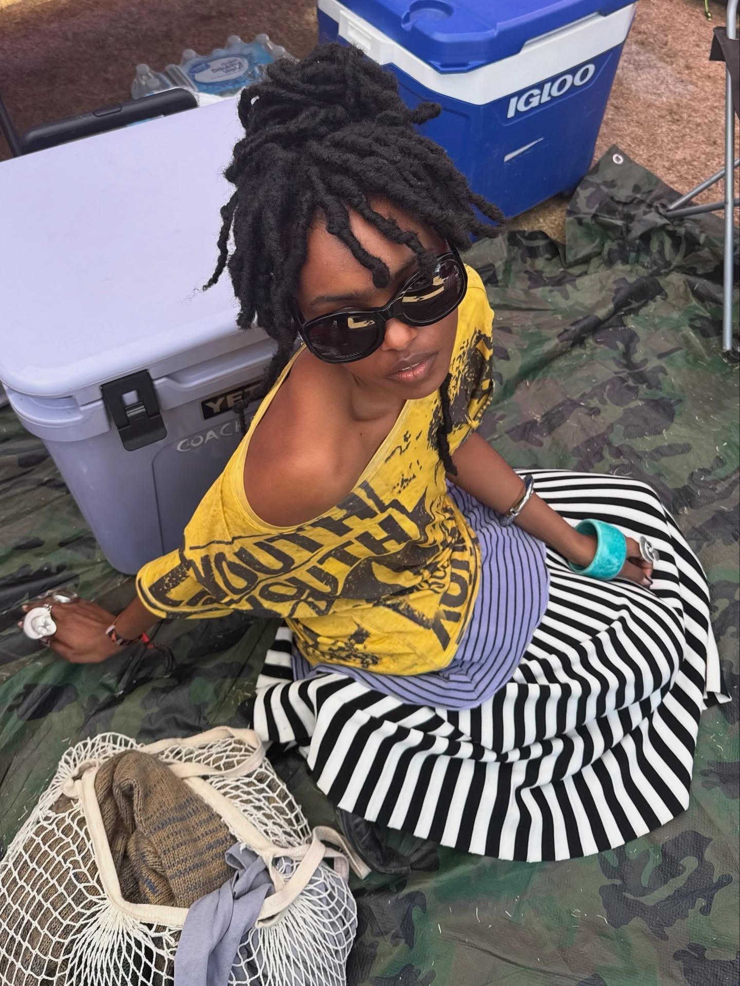 A woman with a loc'd messy bun.