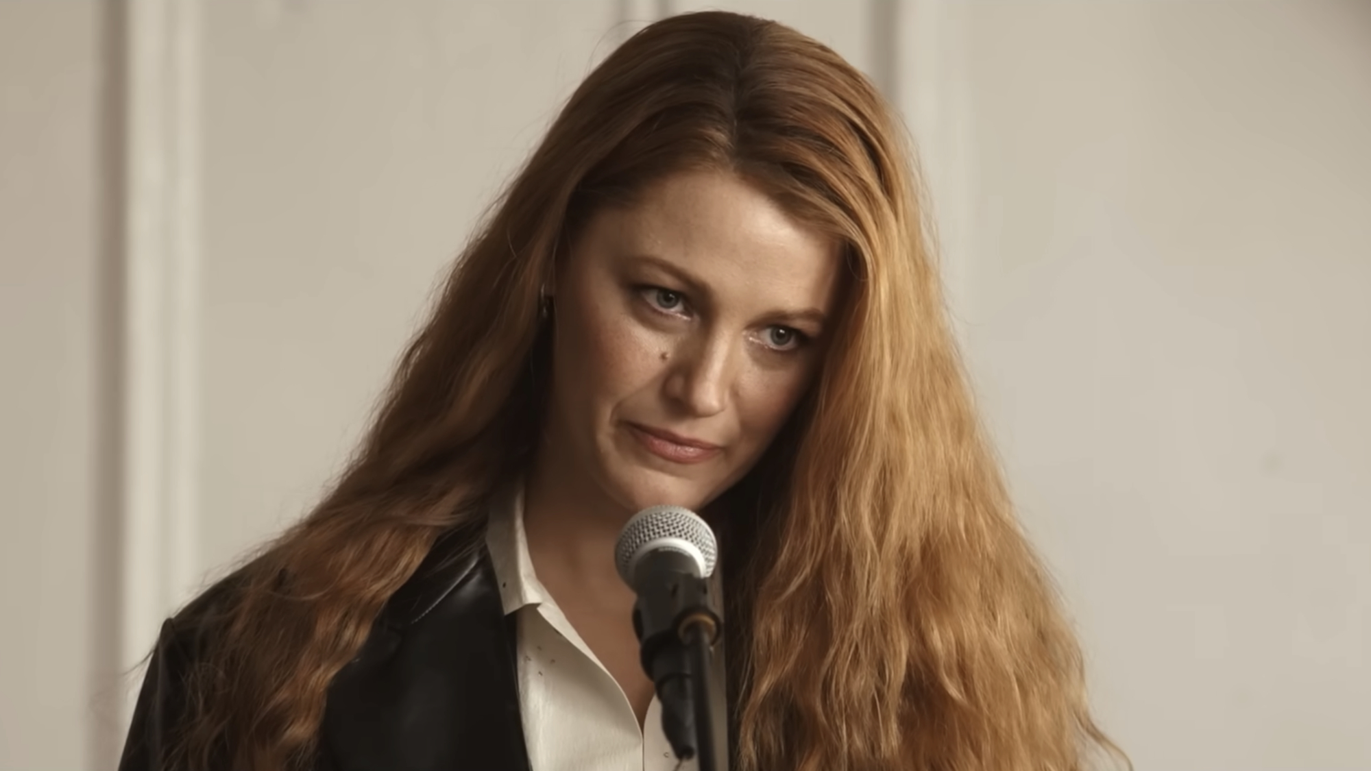 Lily Bloom (Blake Lively) speaks at her father's funeral in It Ends with Us.