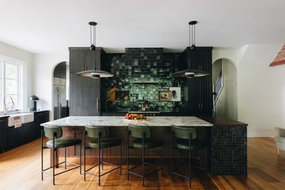 a kitchen with dark tiles
