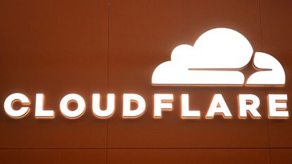 Cloudflare logo and branding illuminated in white coloring against an orange background at the 2026 World Economic Forum (WEF) in Davos. 
