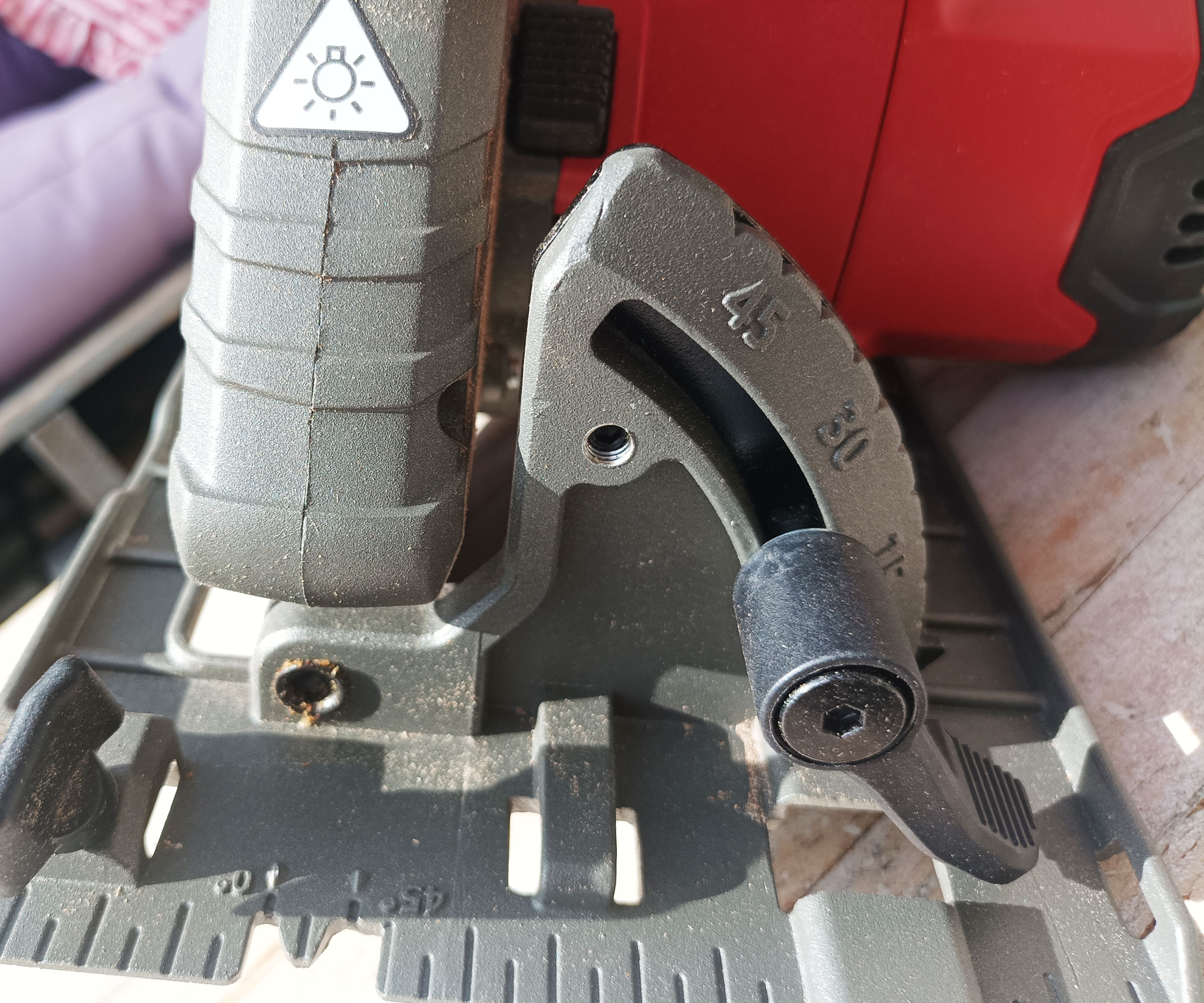 Close up of mitre settings, sole plate and LED light on front of Einhell circular saw