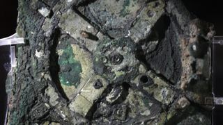 A photo showing part of the remains of the Antikythera mechanism on display in the National Archeological Museum in Athens.