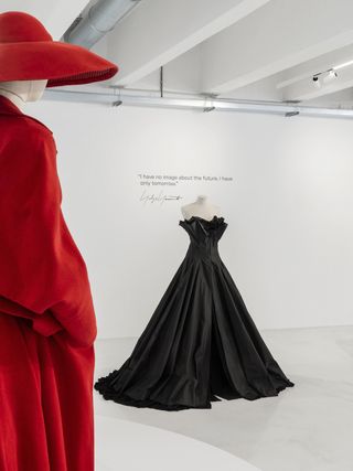 Installation image of Yohji Yamamoto exhibition at 10 Corso Como featuring sculptural black, white and red dresses