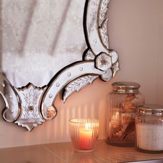 bathroom with candle with glass jar and mirror