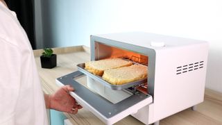Bread being toasted in a toaster oven