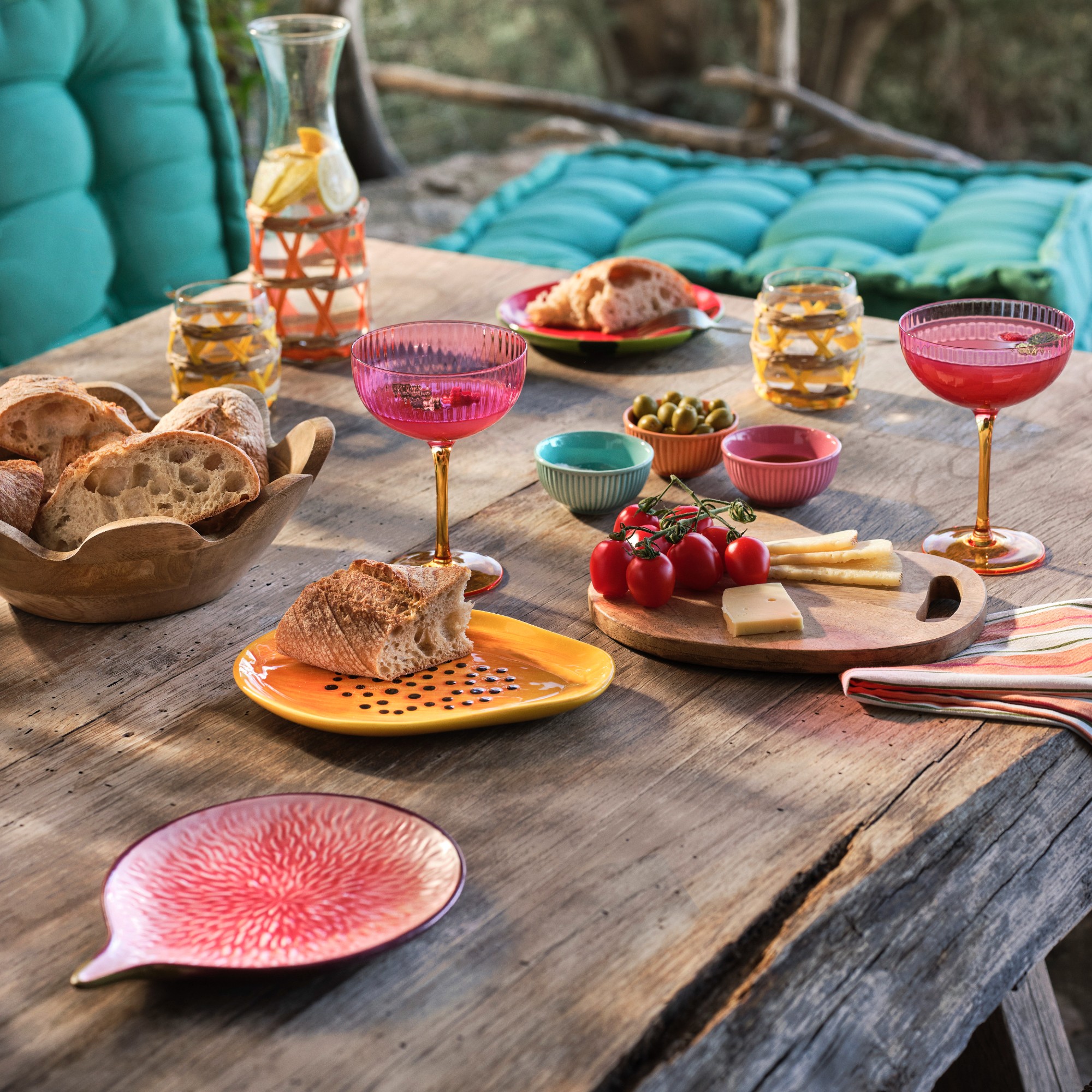 An outdoor table set with fruit tableware and food