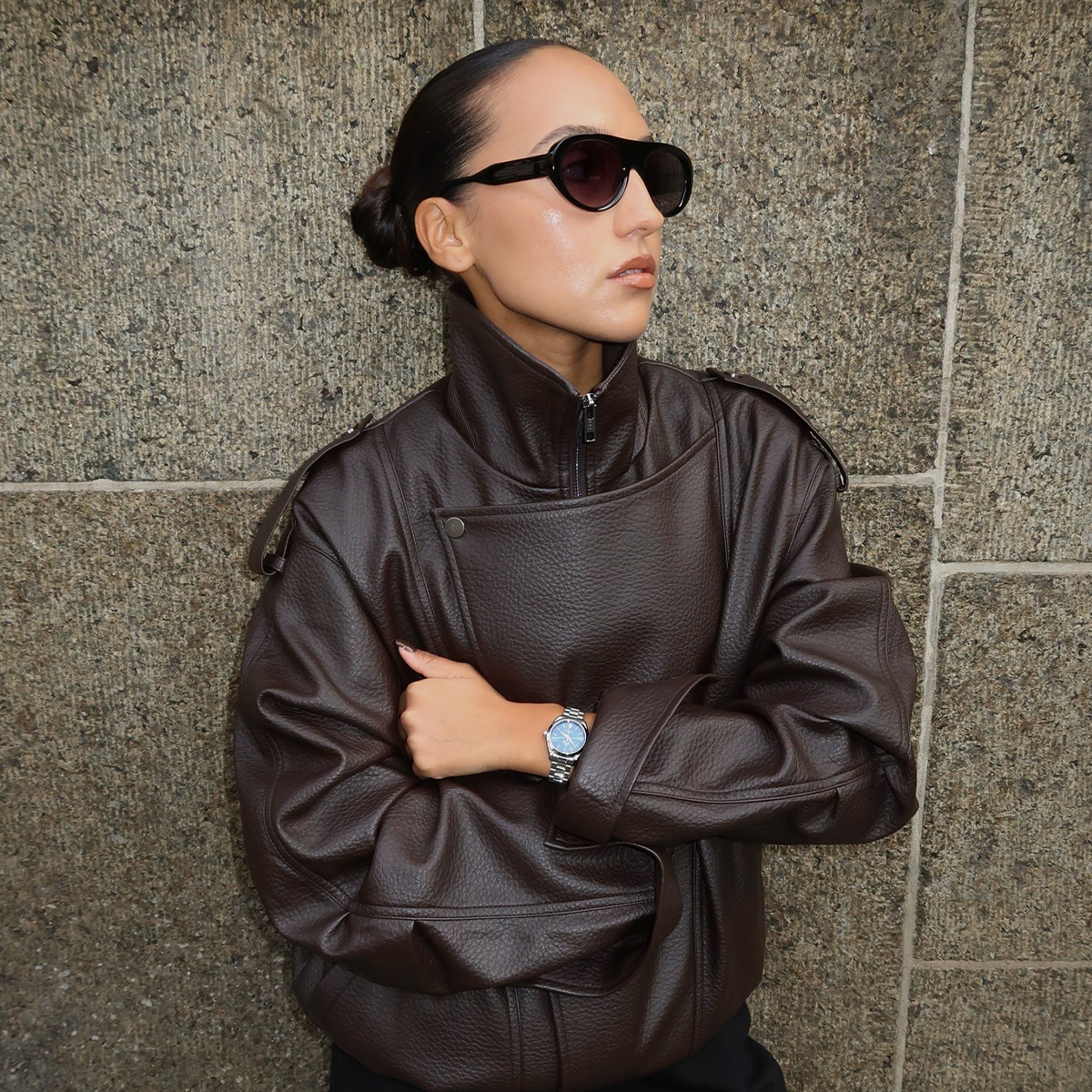 Woman wearing leather funnel neck jacket.