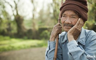 Rural Asian senior man thinking and looking away at sky, by Gawrav Sinha