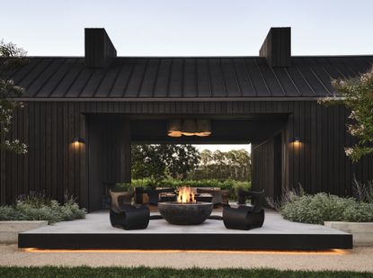 view of a patio, black chairs and a fire pit in napa valley guest house by Nicole Hollis