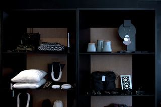 Upclose display of items displayed on a black shelving unit in a store.