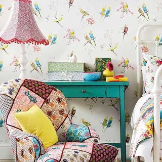 bedroom with floral bed and birdy wallpaper