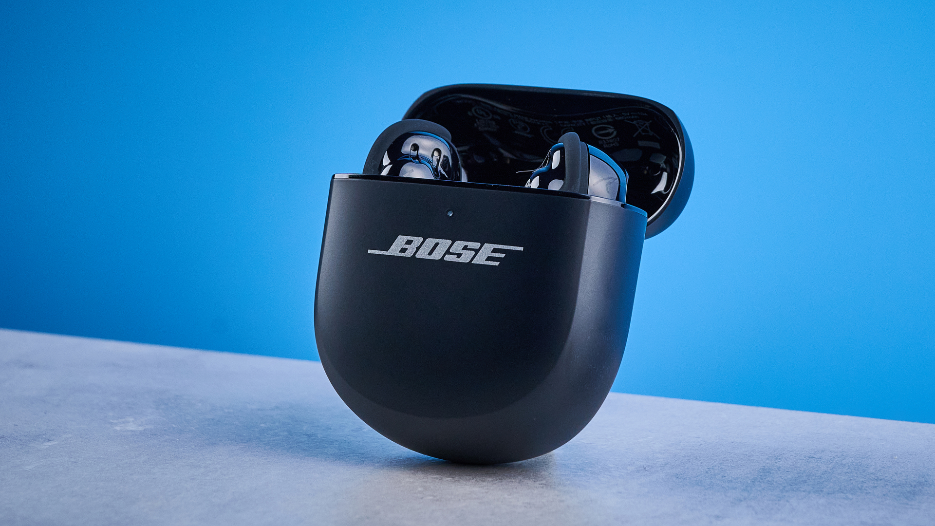 the bose quietcomfort ultra earbuds 2nd gen against the blue tom's guide background