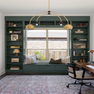 Small office with green shelves and rug