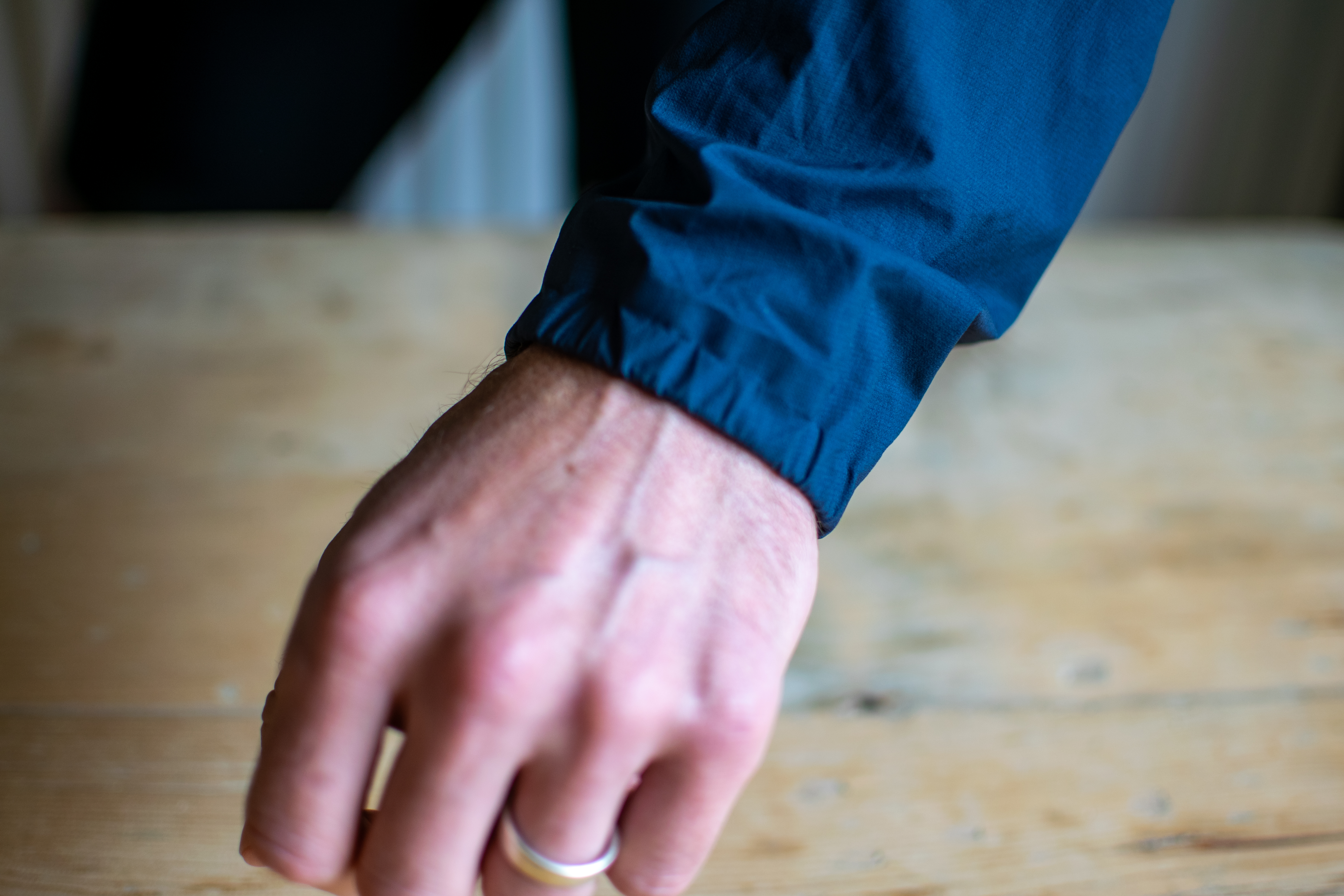 A man wearing a Pas Normal Pertex rain jacket