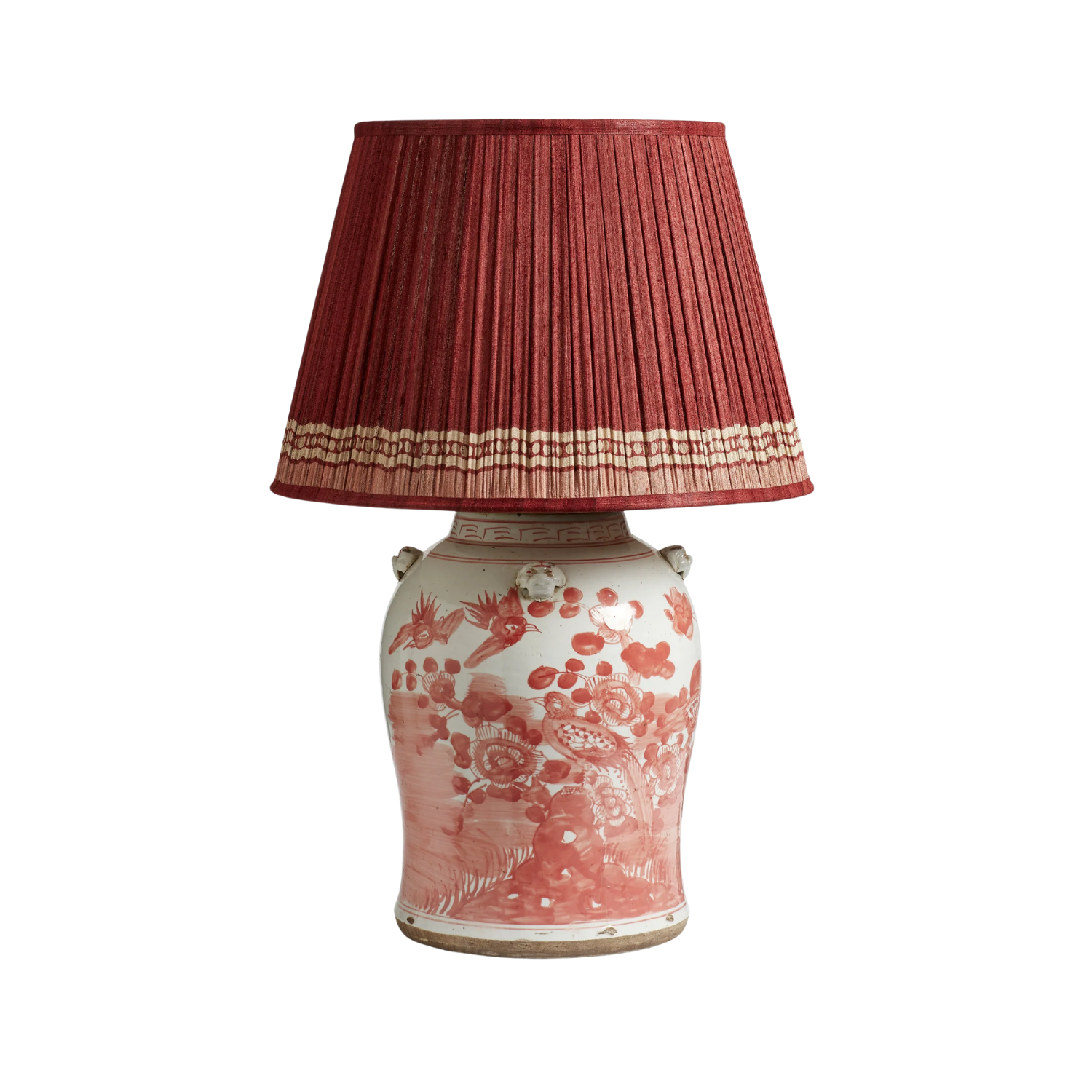 A red lamp with a pleated shade