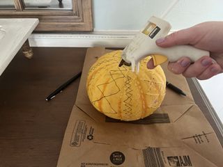 gluing on pumpkin