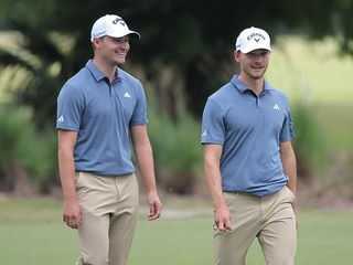 Nicolai and Rasmus Hojgaard walking together on the golf course at the Zurich Classic of New Orleans