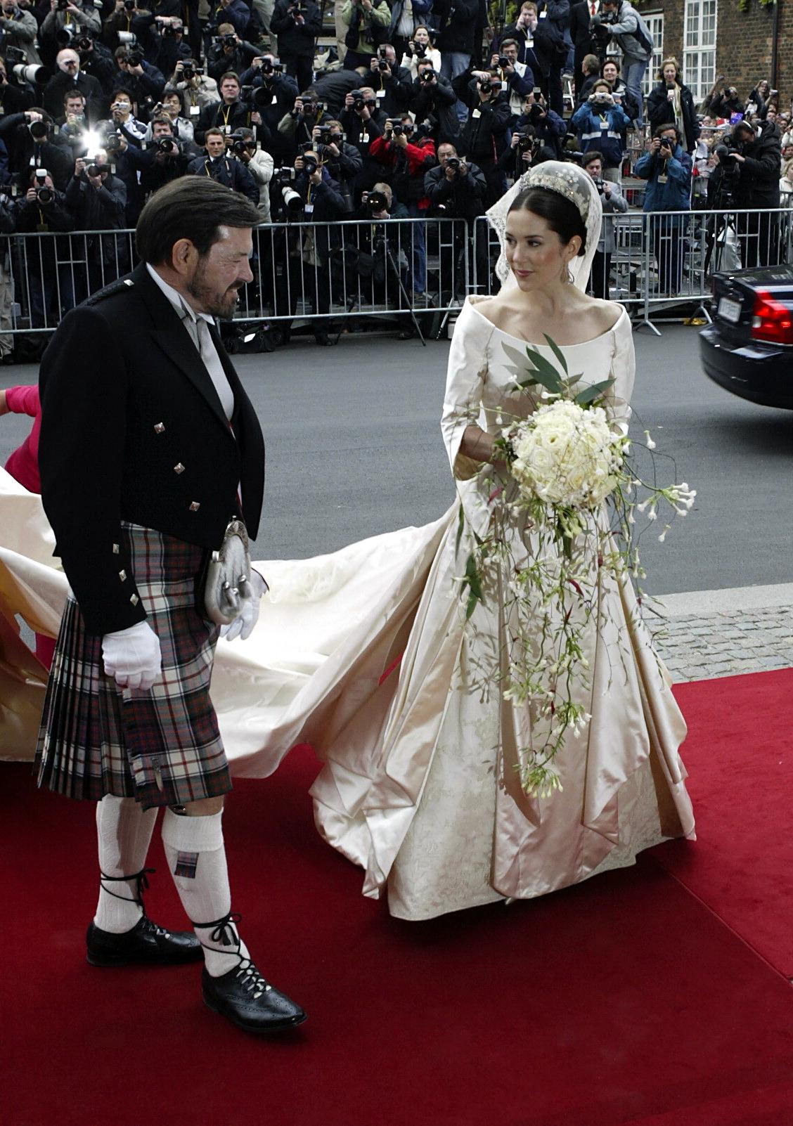Australian Mary Donaldson walks with her father John Donaldson as they arrive at Copenhagen Cathedral for her wedding with Denmark&#039;s Crown Prince Frederik