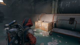 Arc Raiders Water Filter: A player looking at two large metal crates inside the Generator Hall on Dam Battlegrounds.